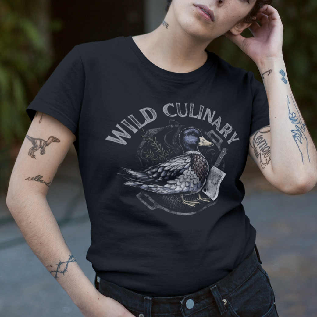 Person wearing a black t-shirt with 'Wild Culinary' design, standing outdoors.