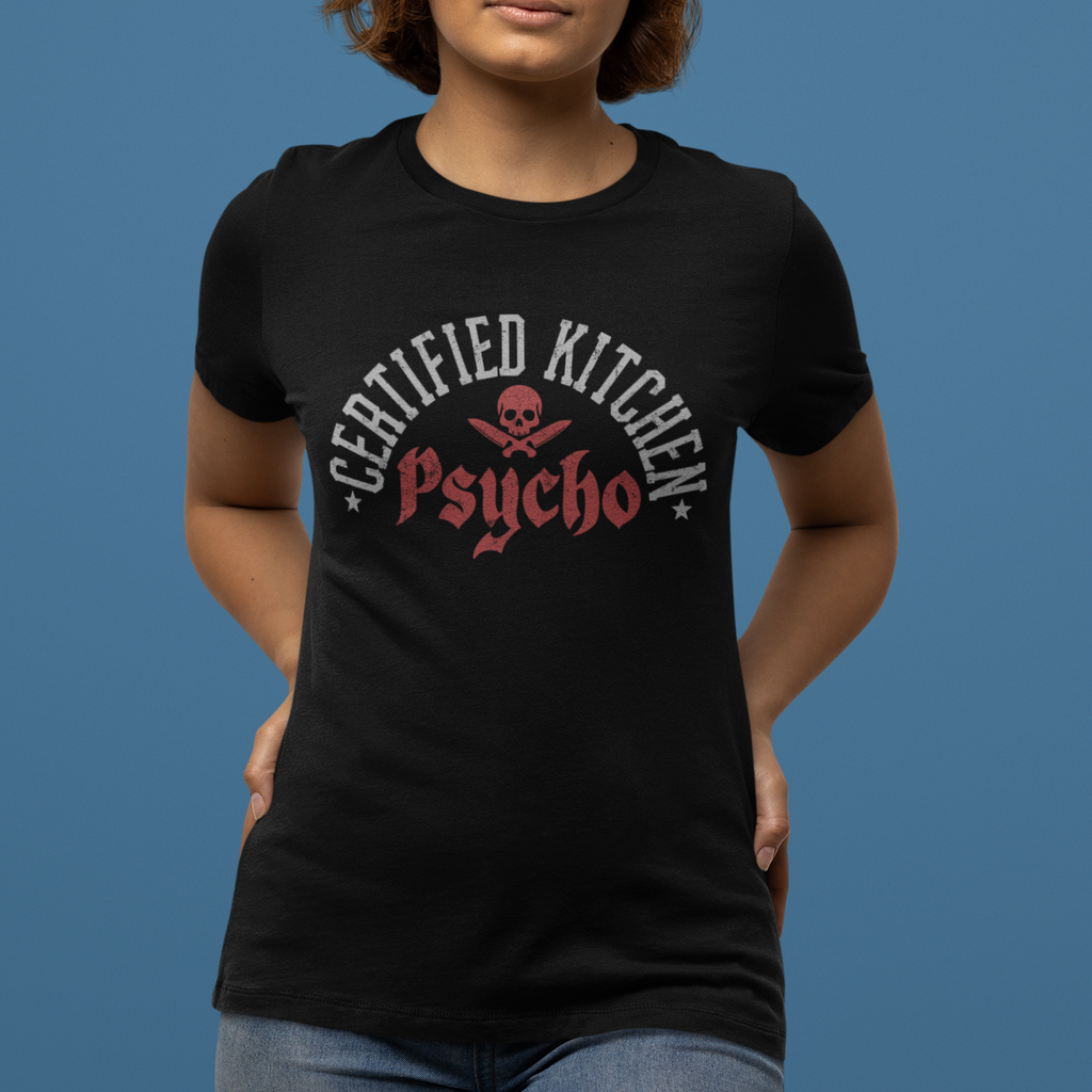 Person wearing a black t-shirt with 'Certified Kitchen Psycho' design on a blue background