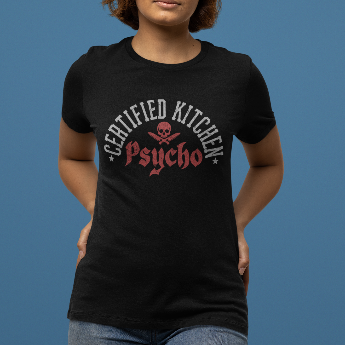 Person wearing a black t-shirt with 'Certified Kitchen Psycho' design on a blue background