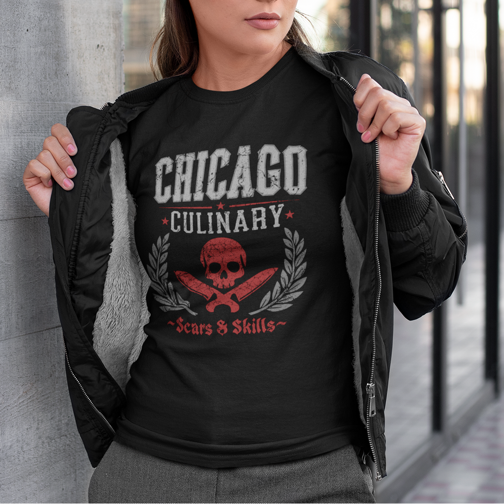 Woman wearing a black t-shirt with 'Chicago Culinary' design, standing against a building.