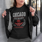 Woman wearing a black t-shirt with 'Chicago Culinary' design, standing against a building.