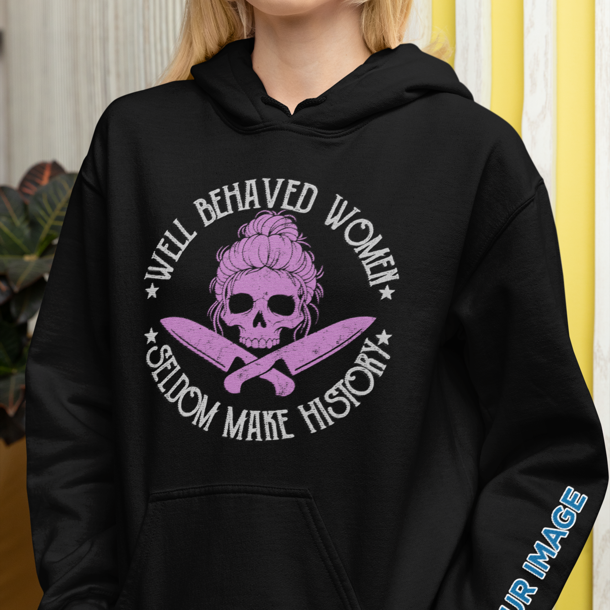 Person wearing a black hoodie with a graphic design and text.