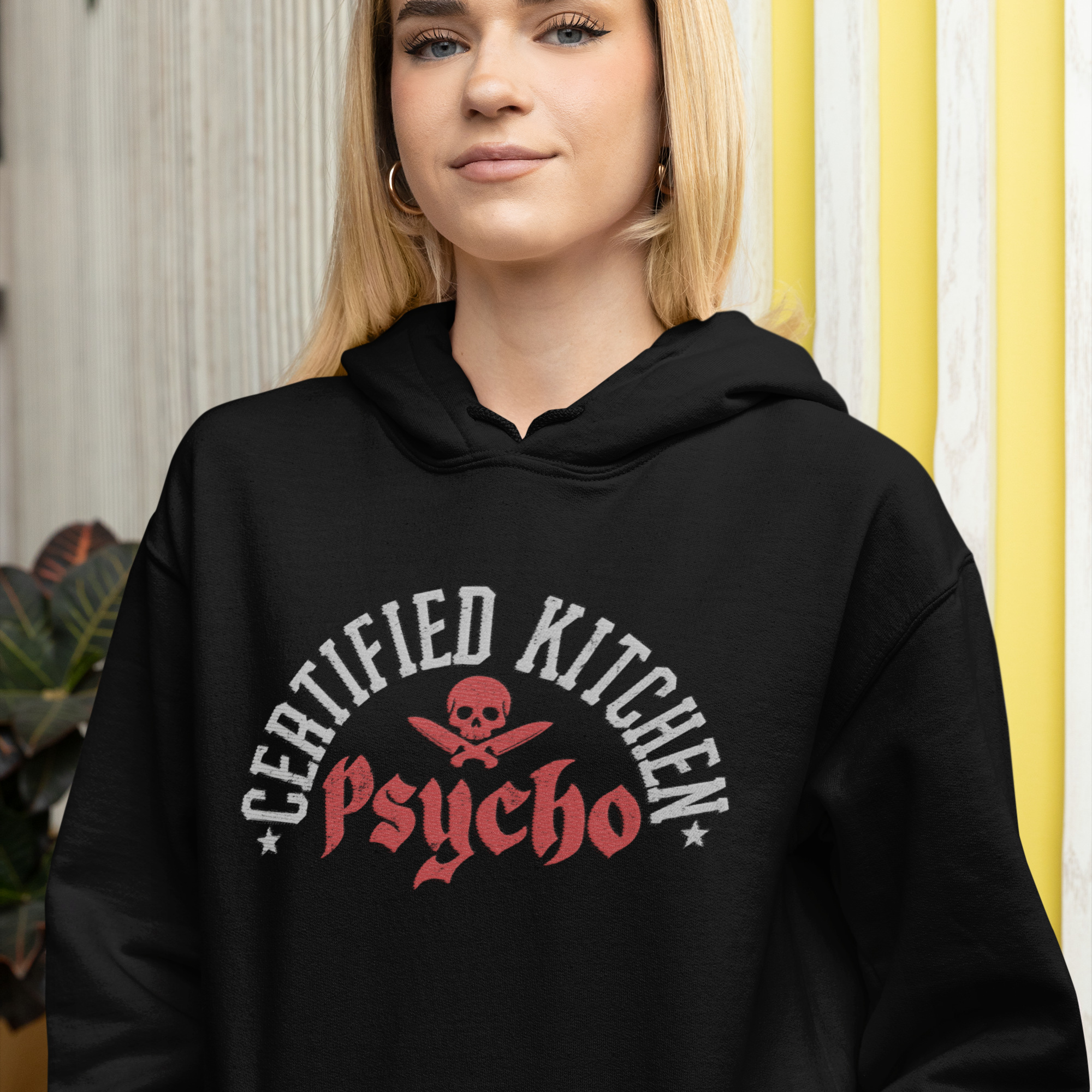 Person wearing a black hoodie with 'Certified Kitchen Psycho' design