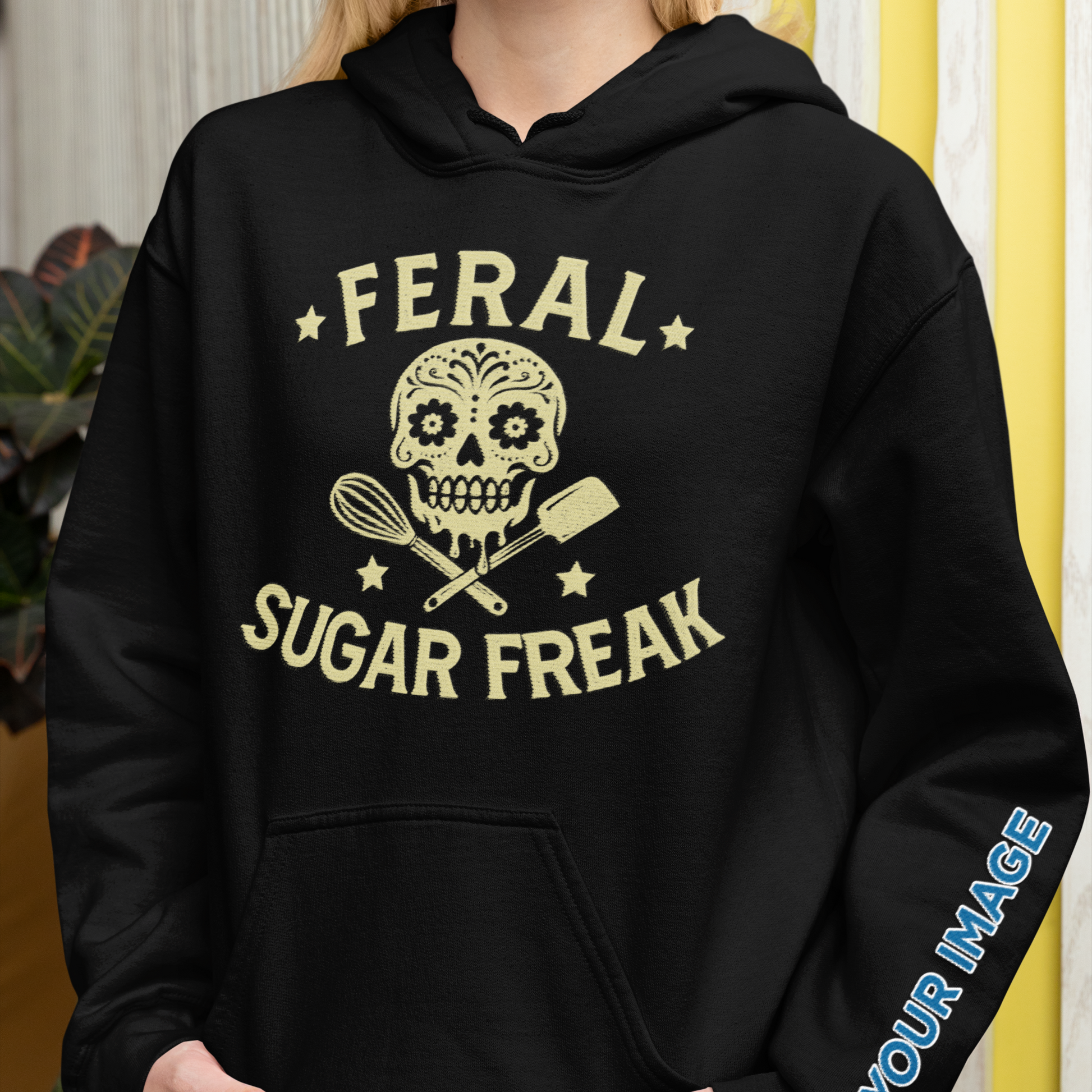 Person wearing a black hoodie with 'Feral Sugar Freak' design and customizable text on sleeve.