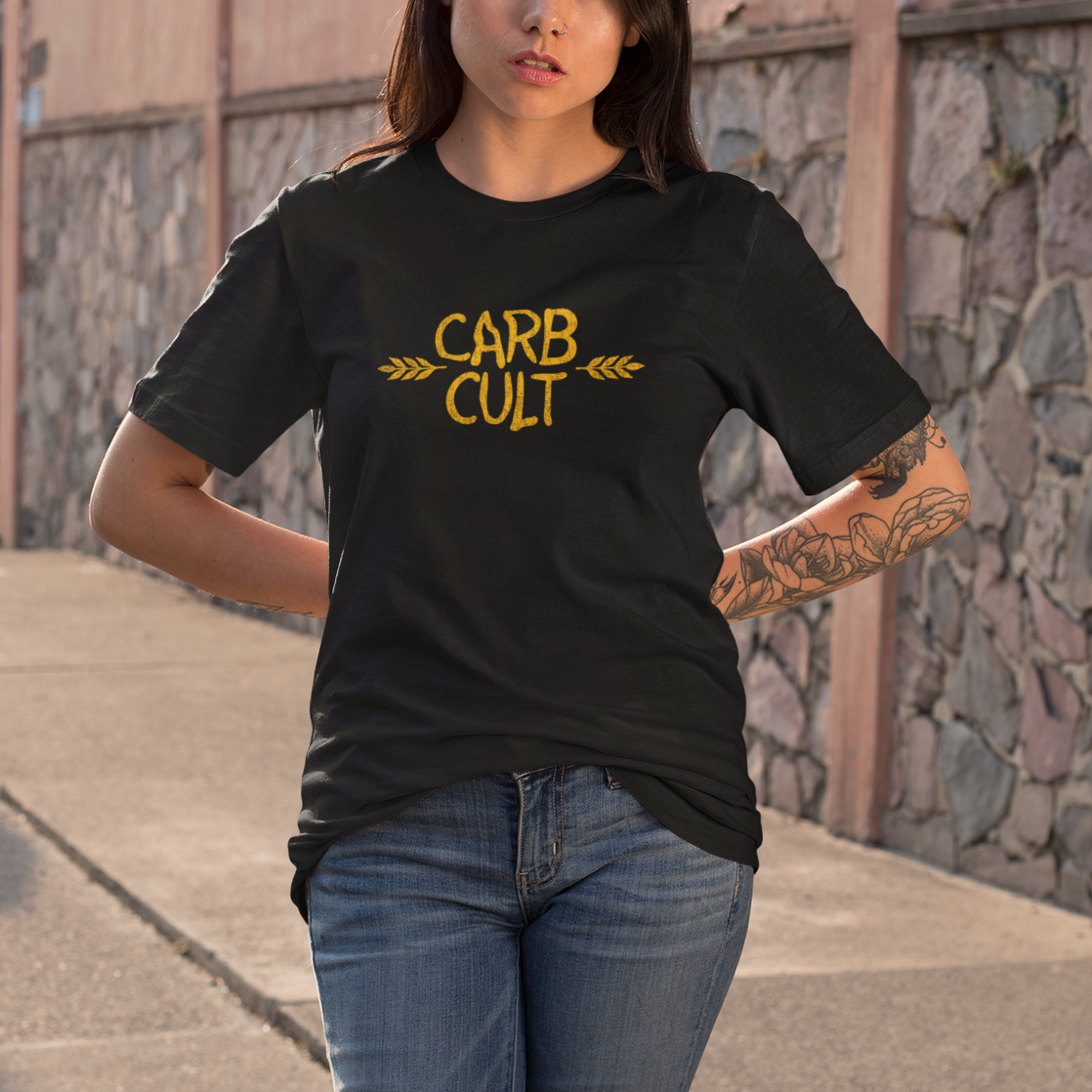Woman wearing a black t-shirt with 'CARB CULT' text on a stone wall background