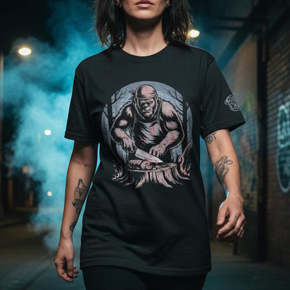 Person wearing a black t-shirt with a graphic design on a street at night.