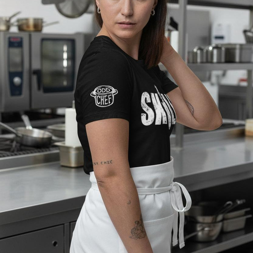 Person wearing a black 'Chef' t-shirt in a kitchen setting