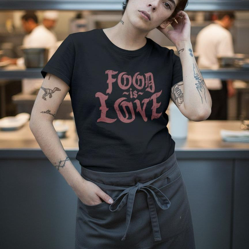 Person wearing a black t-shirt with 'Food is Love' text in a kitchen setting