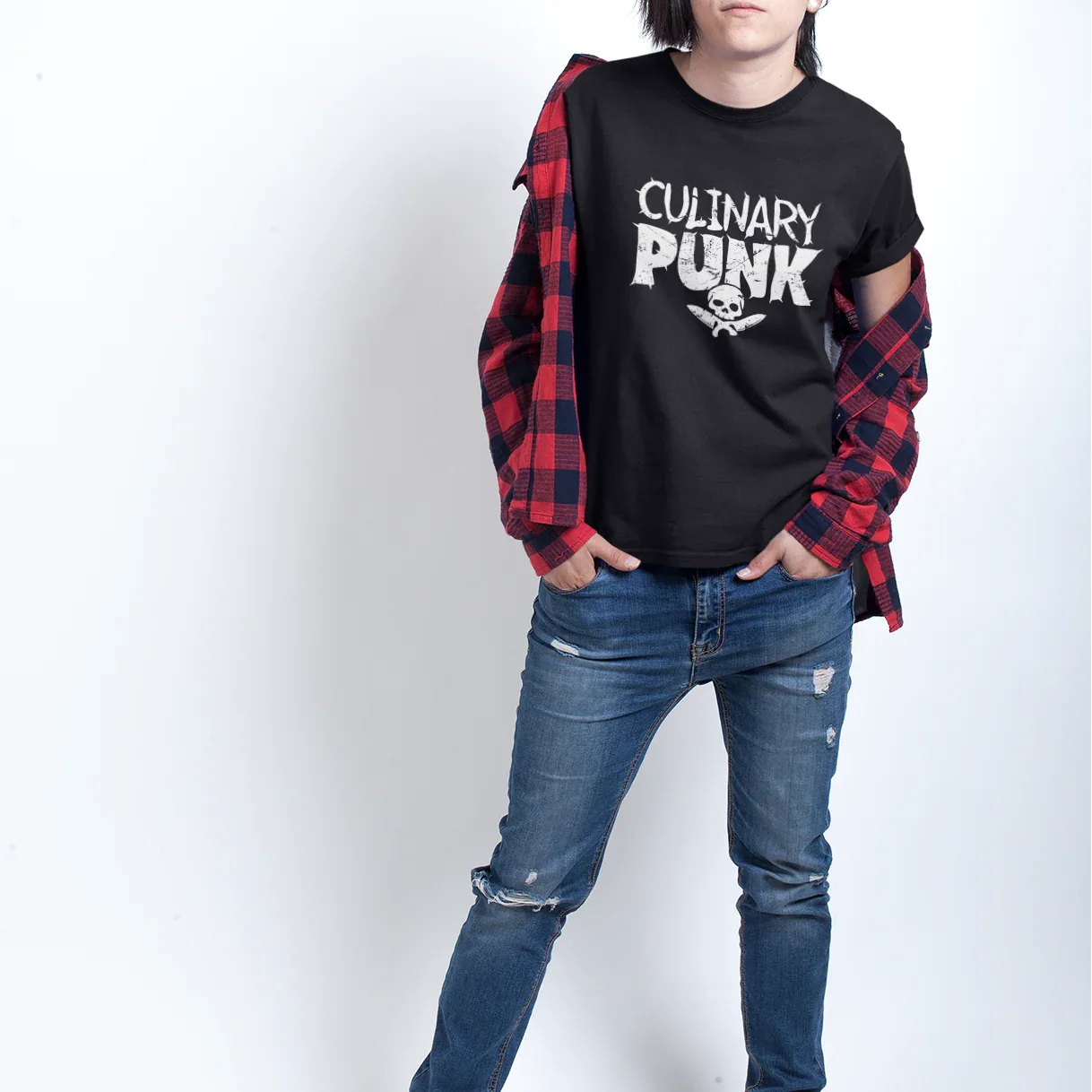 Person wearing a black 'Culinary Punk' t-shirt with a red plaid shirt over it, blue jeans, and white sneakers on a white background.