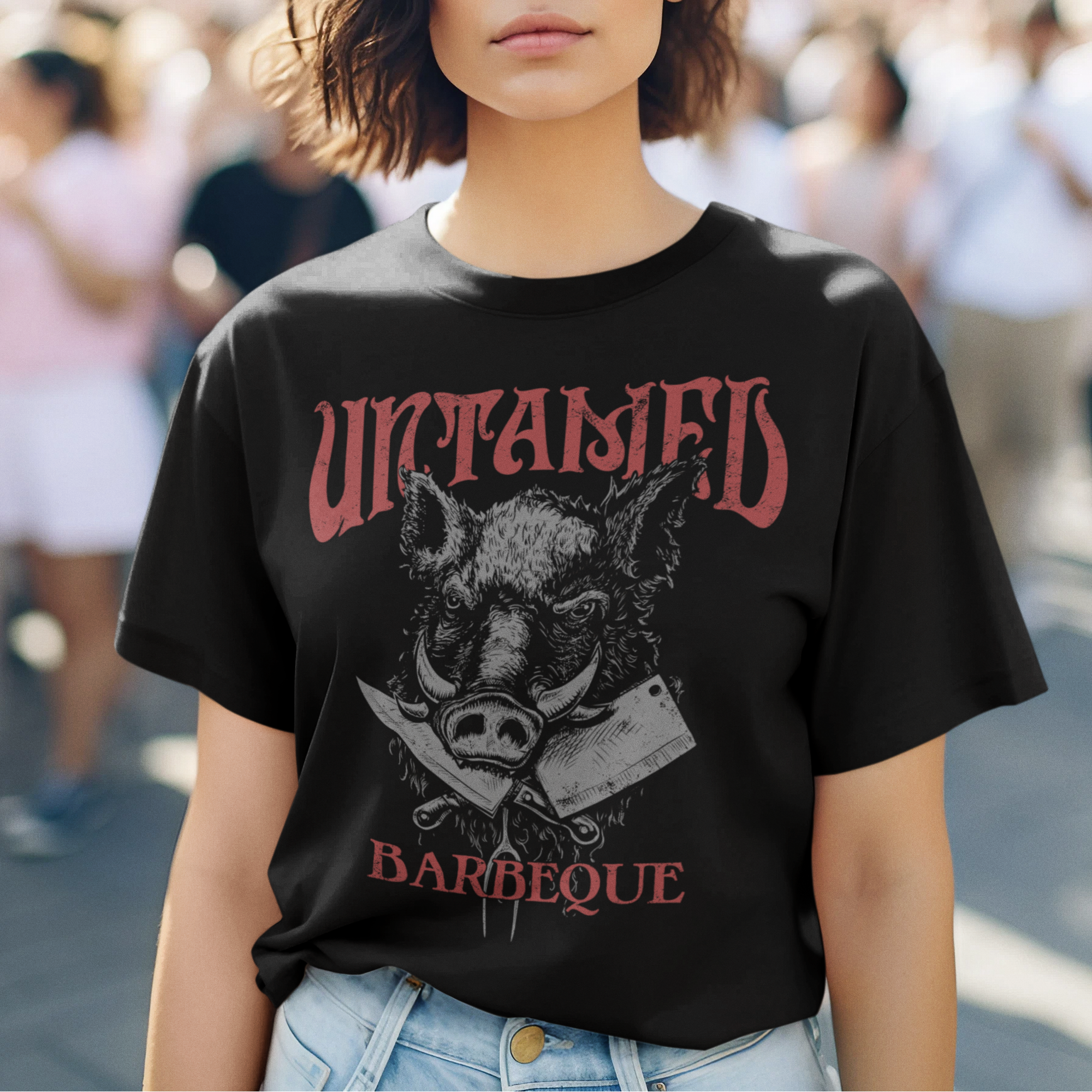 Person wearing a black t-shirt with a graphic design and text, standing in an outdoor setting.