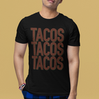 Person wearing a black t-shirt with 'TACOS TACOS TACOS' text and blue plaid pants on a beige background