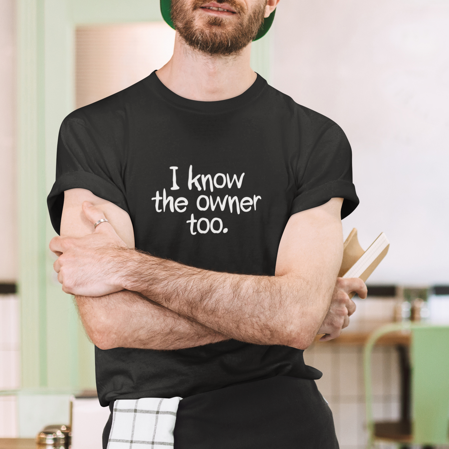 Man wearing a black t-shirt with text, standing in an indoor setting.