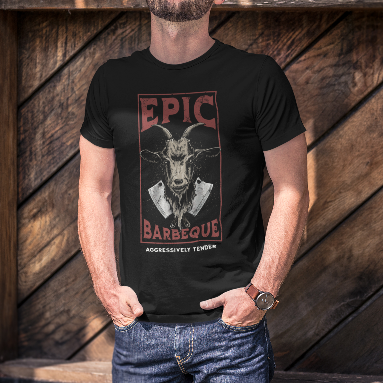 Person wearing a black t-shirt with 'Epic Barbecue' graphic design against a wooden background
