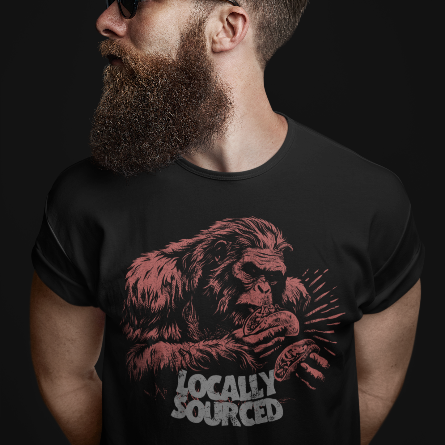 Man wearing a black t-shirt with a graphic design and text on a dark background