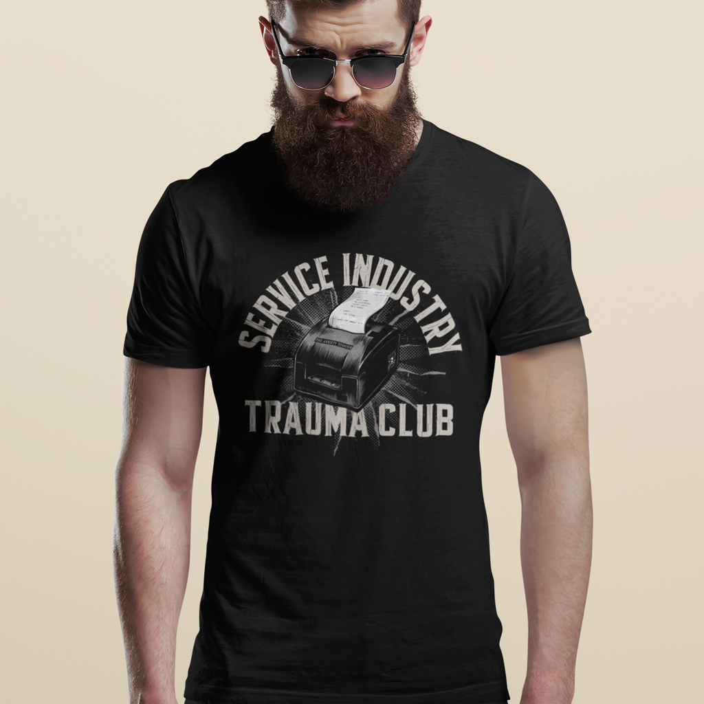 Man wearing a black t-shirt with 'Service Industry Trauma Club' text and graphic on a beige background
