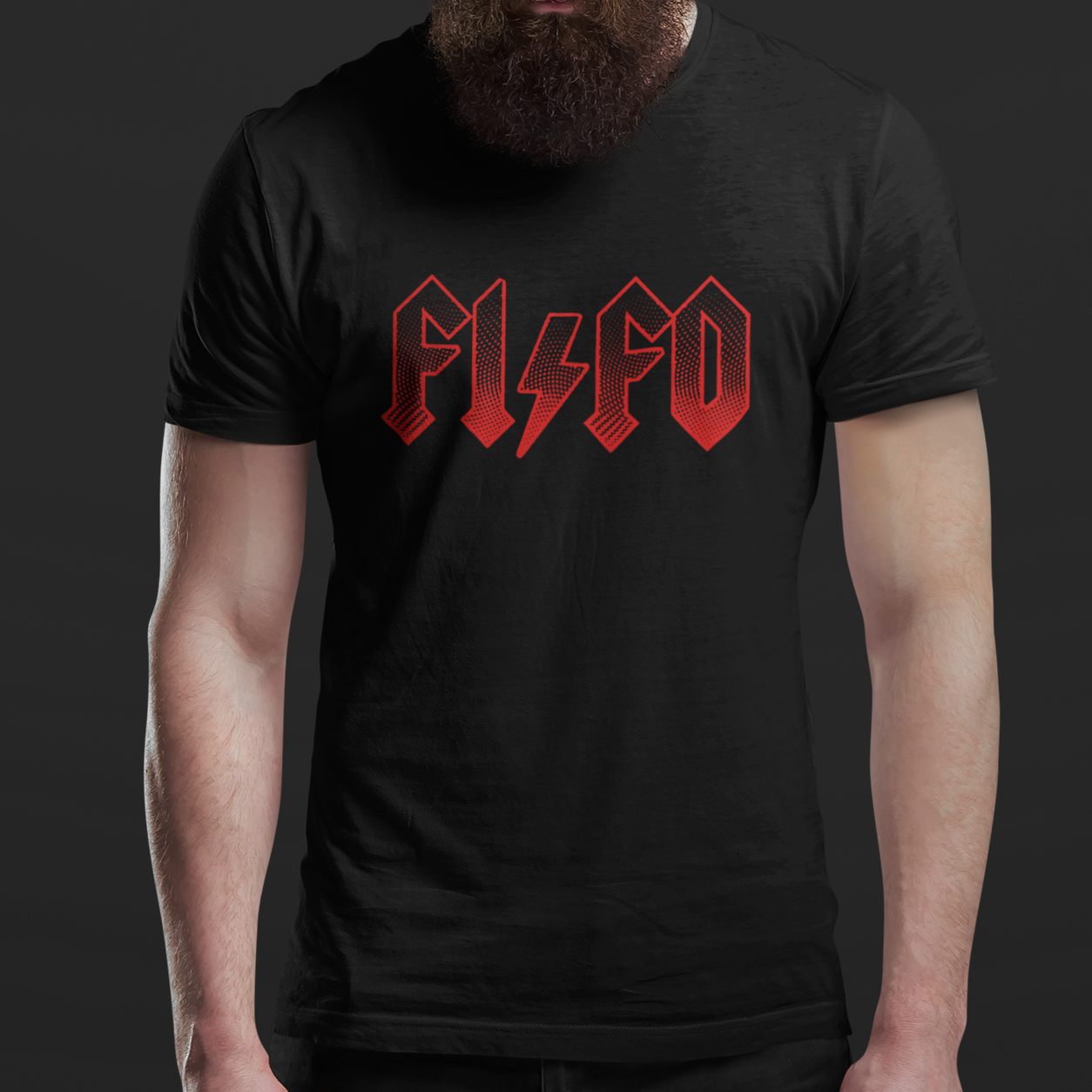 A man with a full beard and sunglasses wearing a black t-shirt with a red stylized 'PLSCO' graphic on the chest, posed against a dark gray studio background.