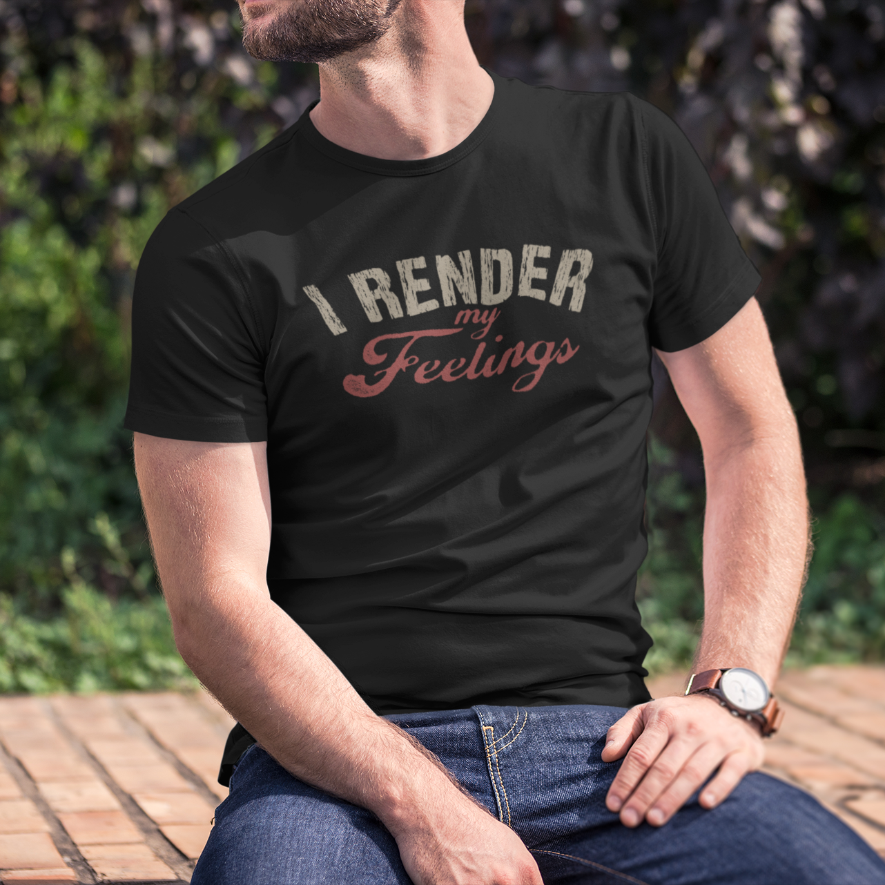 Person wearing a black t-shirt with 'I RENDER my Feelings' text sitting outdoors.