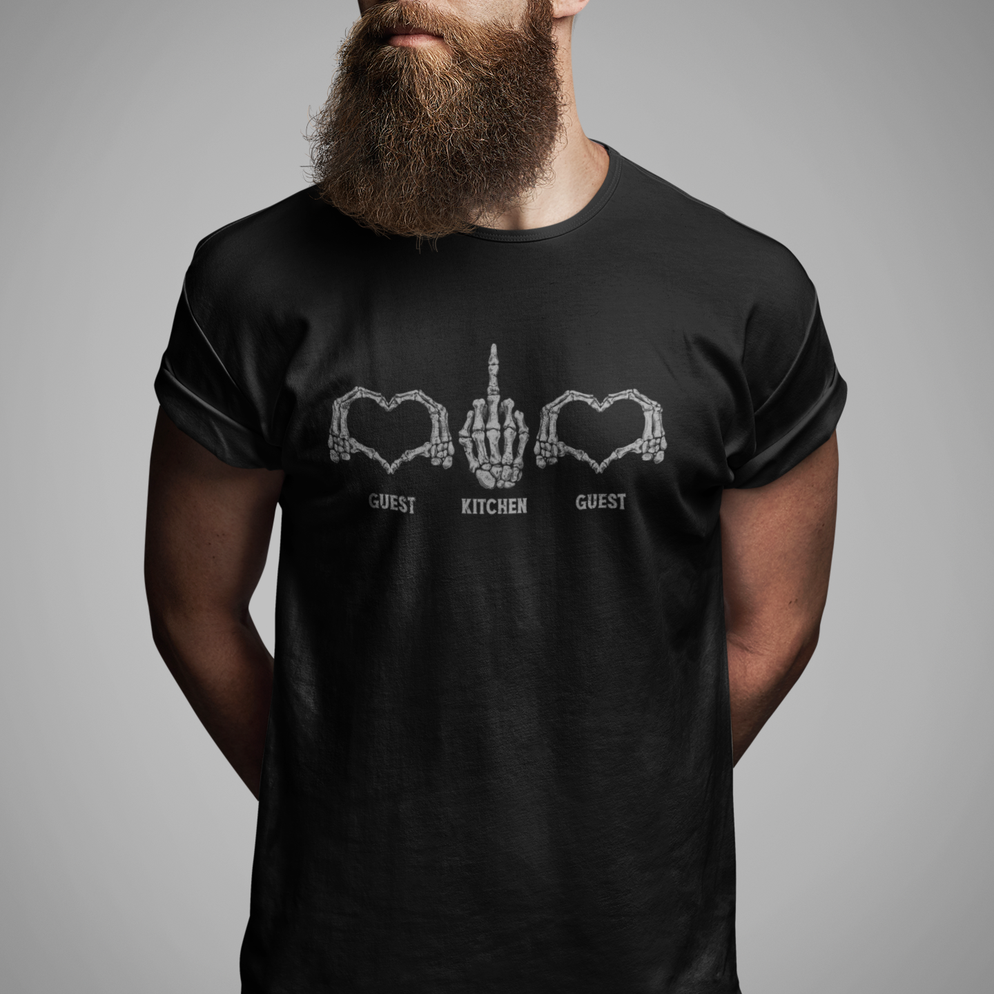 A man with a full beard and sunglasses wearing a black t-shirt with a white graphic of a hand between two hearts and the words 'GUEST KITCHEN GUEST'.