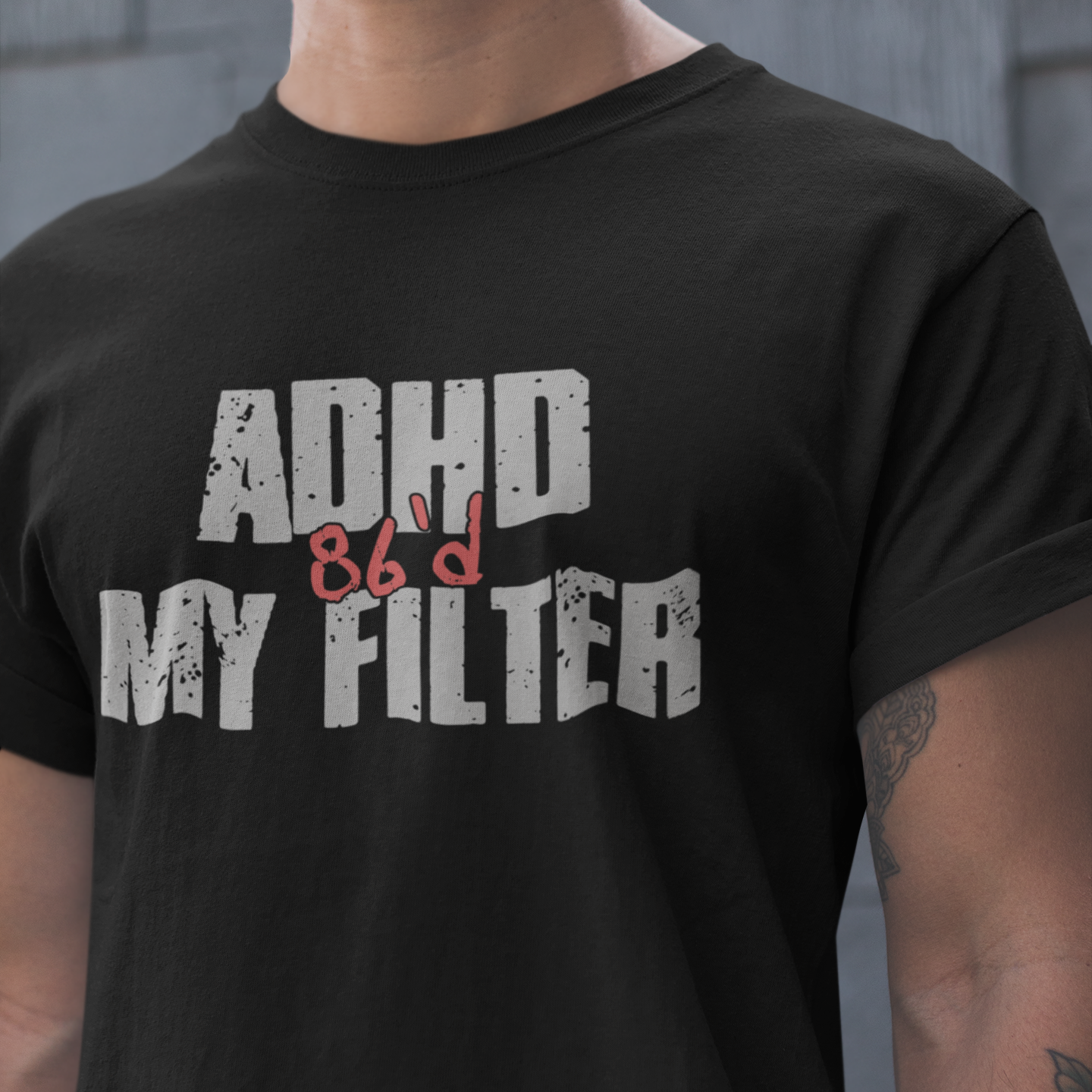Person wearing a black t-shirt with 'ADHD 86'd my filter' text.
