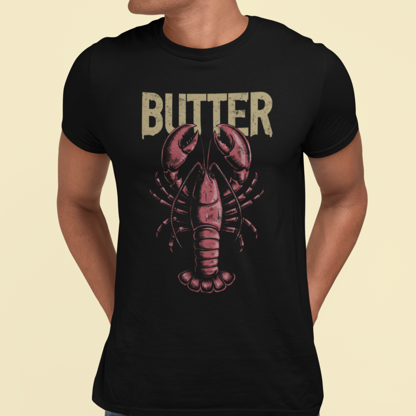 Person wearing a black t-shirt with a lobster graphic and 'BUTTER' text on a beige background