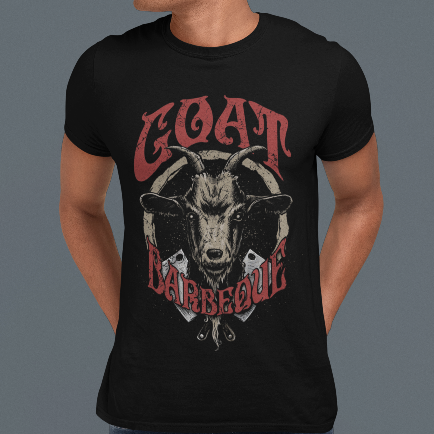 Person wearing a black t-shirt with a graphic of a goat and the text 'GOAT BARBECUE' on a gray background