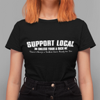 Person wearing a black t-shirt with 'Support Local' text on a gray background