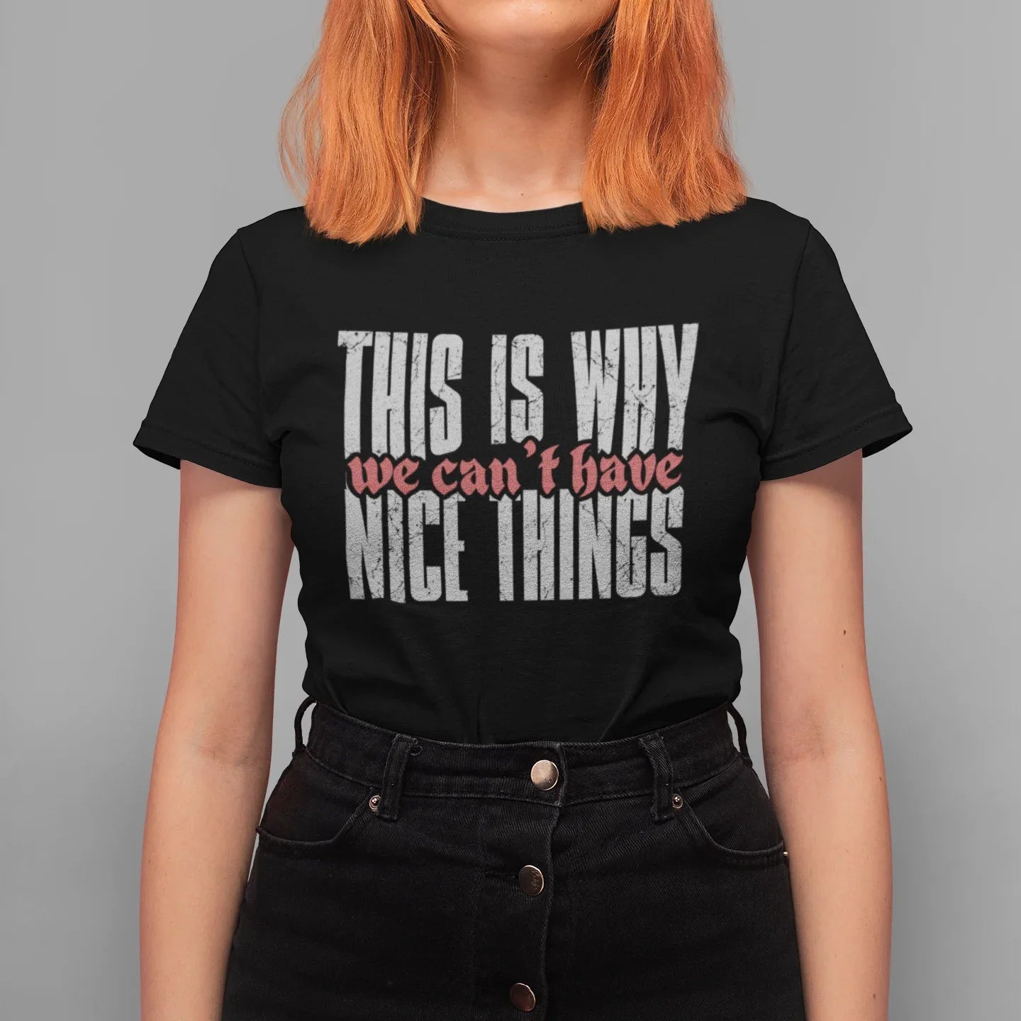 Person wearing a black t-shirt with text on a gray background