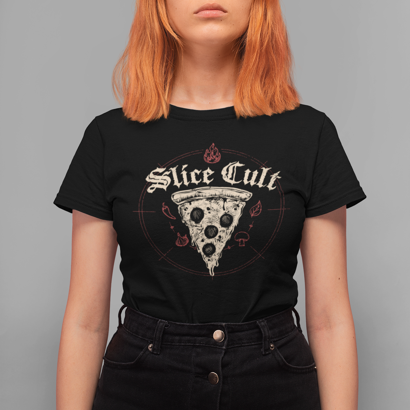 A model with bright orange hair wearing a black graphic t-shirt featuring a pizza slice with a skull and the text 'Slice Cult'.
