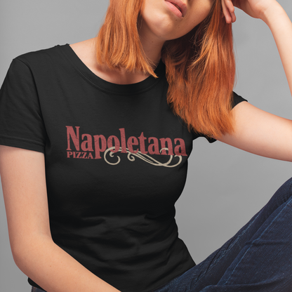 A woman with orange hair wearing a black t-shirt with 'Napoletana Pizza' printed in red and white, posed against a solid gray background.