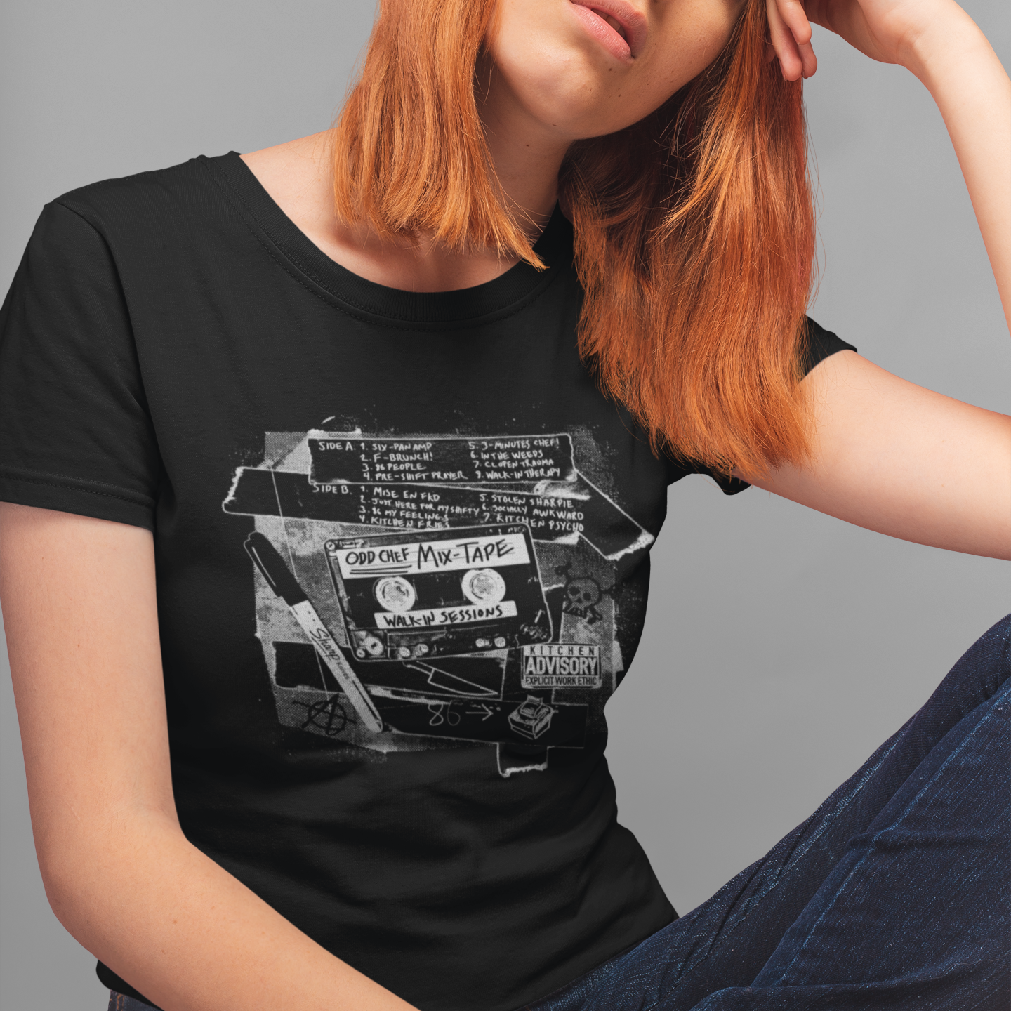 Person wearing a black t-shirt with a graphic design on a gray background