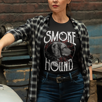 Woman wearing a 'Smoke Hound' t-shirt standing next to a motorcycle in an industrial setting.