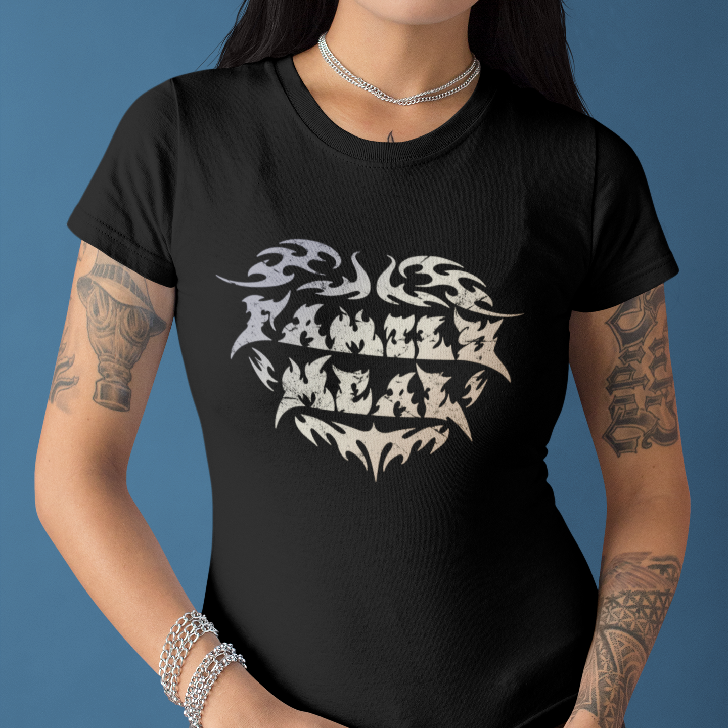 Person wearing a black t-shirt with white graphic design on a blue background