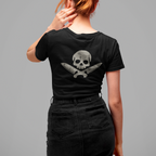Person wearing a black t-shirt with a skull and crossbones design on the back, standing against a gray background.