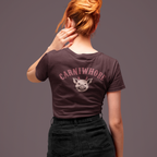 Person wearing a dark t-shirt with 'Carniwhore' design on the back against a gray background