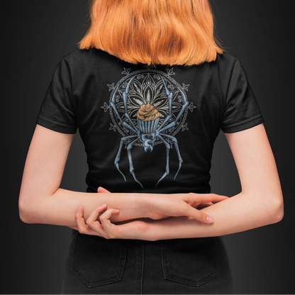 A person viewed from behind wearing a black short-sleeve T-shirt with a large detailed spider graphic on the back, set against a dark studio background.