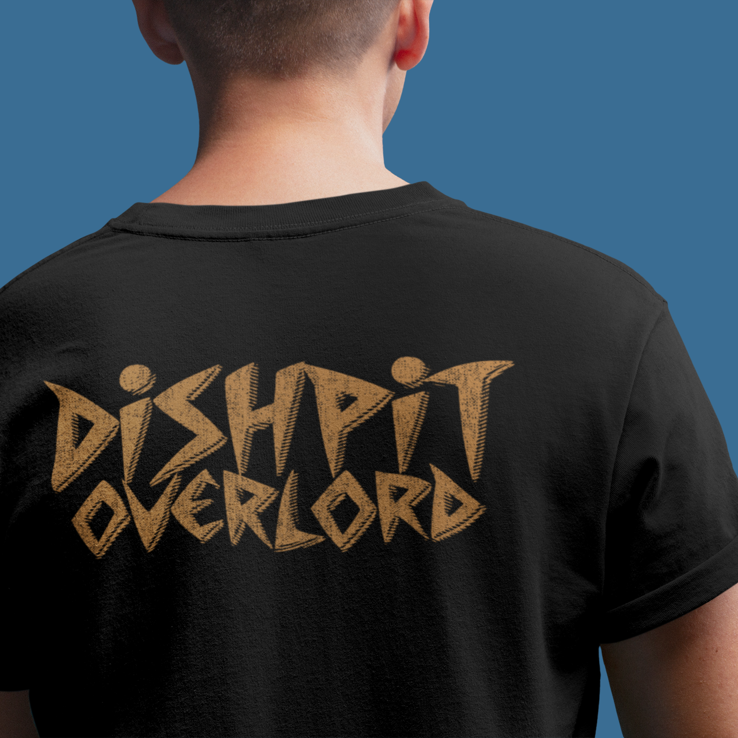 A person shown from the back wearing a black t-shirt with a large textured gold graphic reading 'DISHPIT OVERLORD' on the back, set against a solid blue background.
