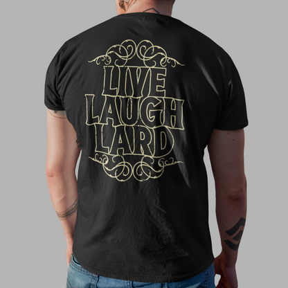A man viewed from behind wearing a black t-shirt with a gold graphic that reads 'LIVE LAUGH LARD' and blue jeans, set against a solid gray background.