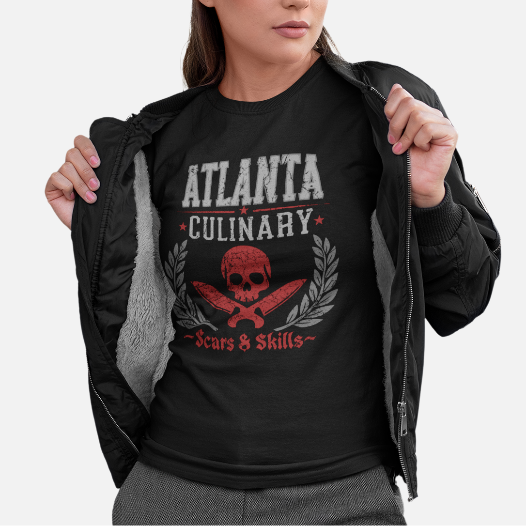 Woman wearing a black t-shirt with 'Atlanta Culinary' design on a white background