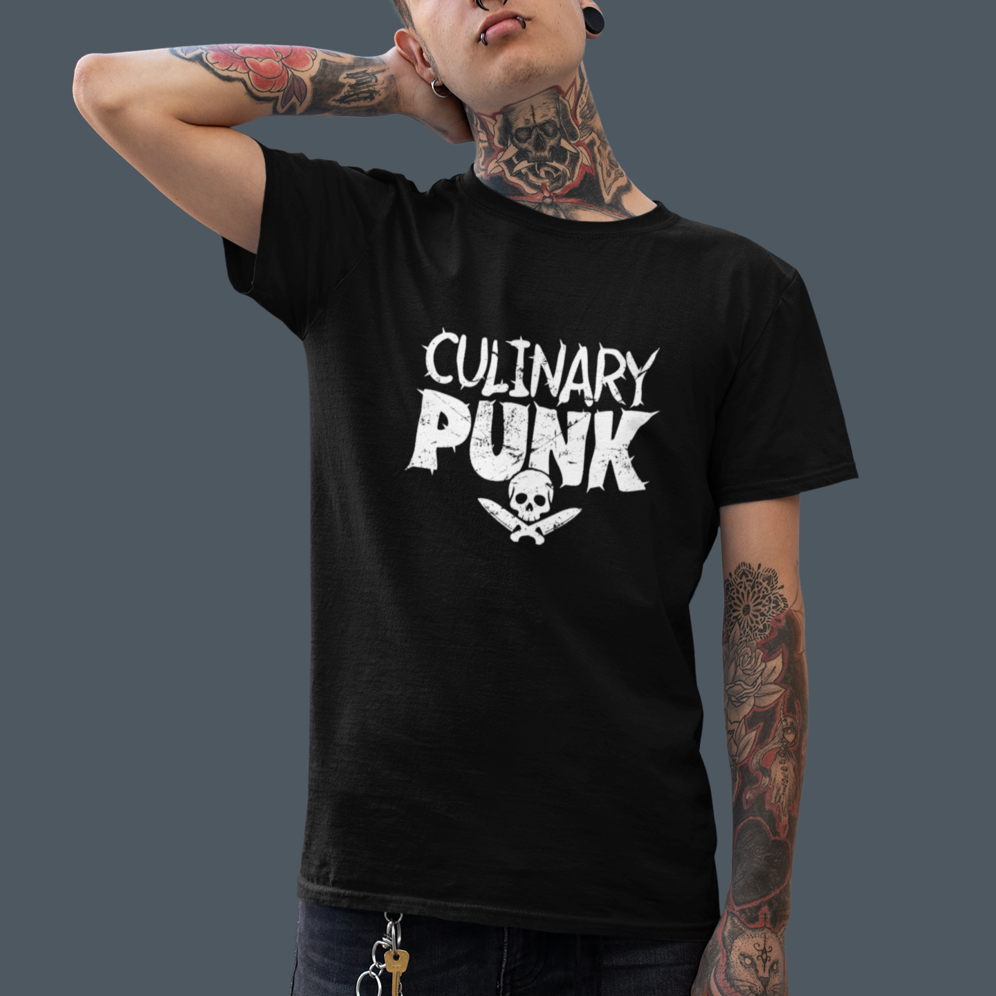 Person wearing a black t-shirt with 'Culinary Punk' text and skull design on a gray background