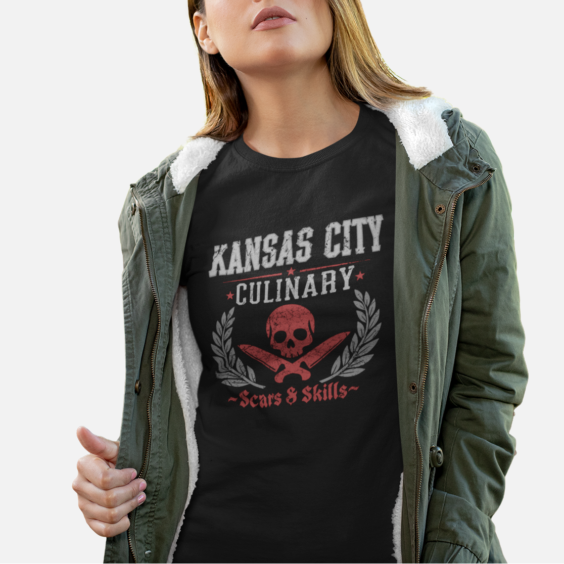 Person wearing a black t-shirt with 'Kansas City Culinary' design, standing against a plain background