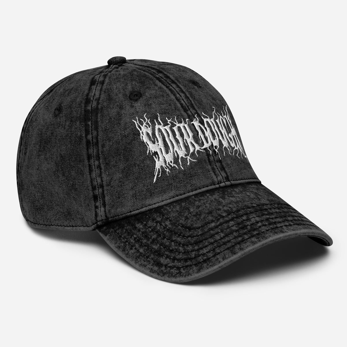 Black cap with 'BEHIND' text on a white background