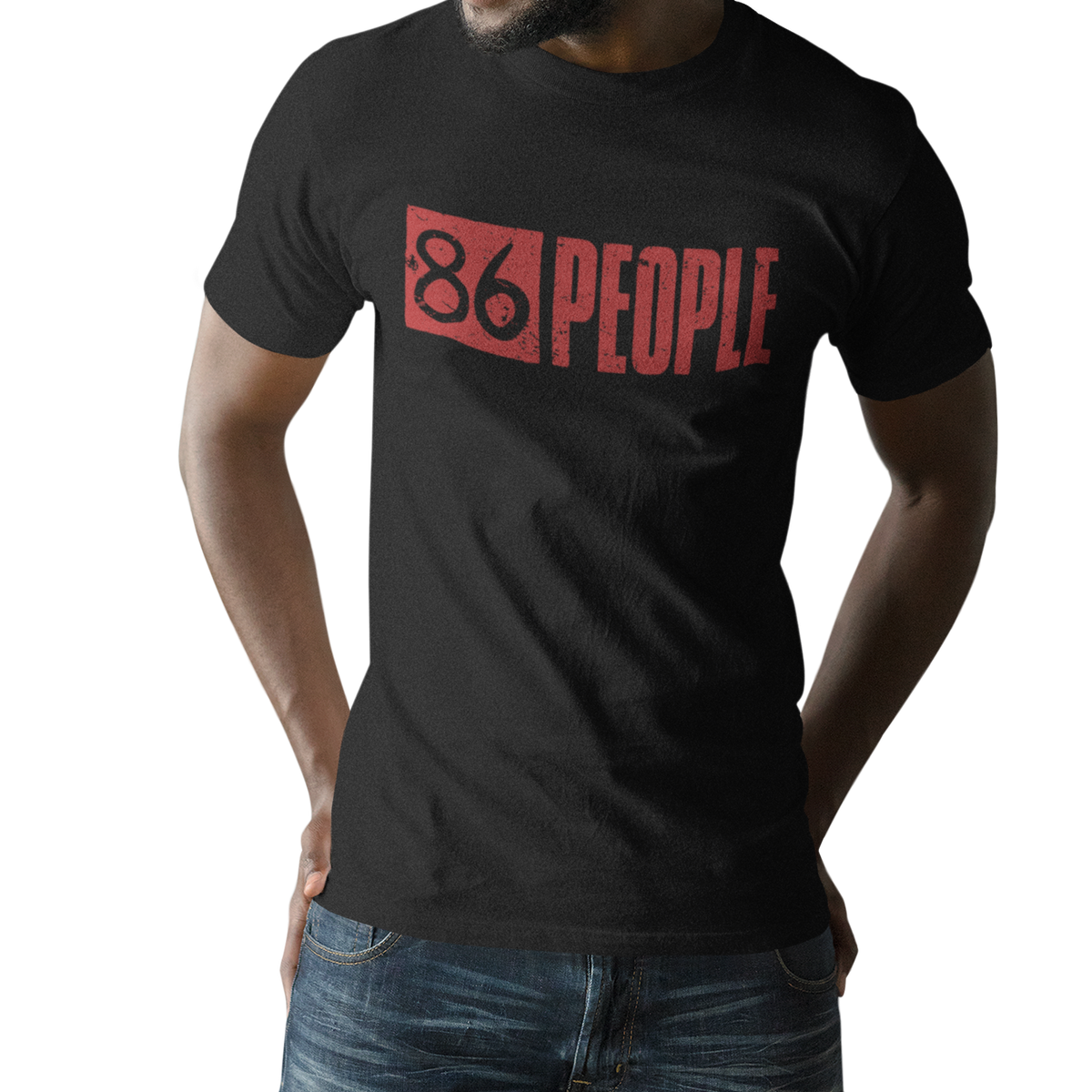 A man wearing a black short-sleeve t-shirt with a distressed red graphic that reads '86 PEOPLE' across the chest, paired with blue jeans, shown against a plain white background.